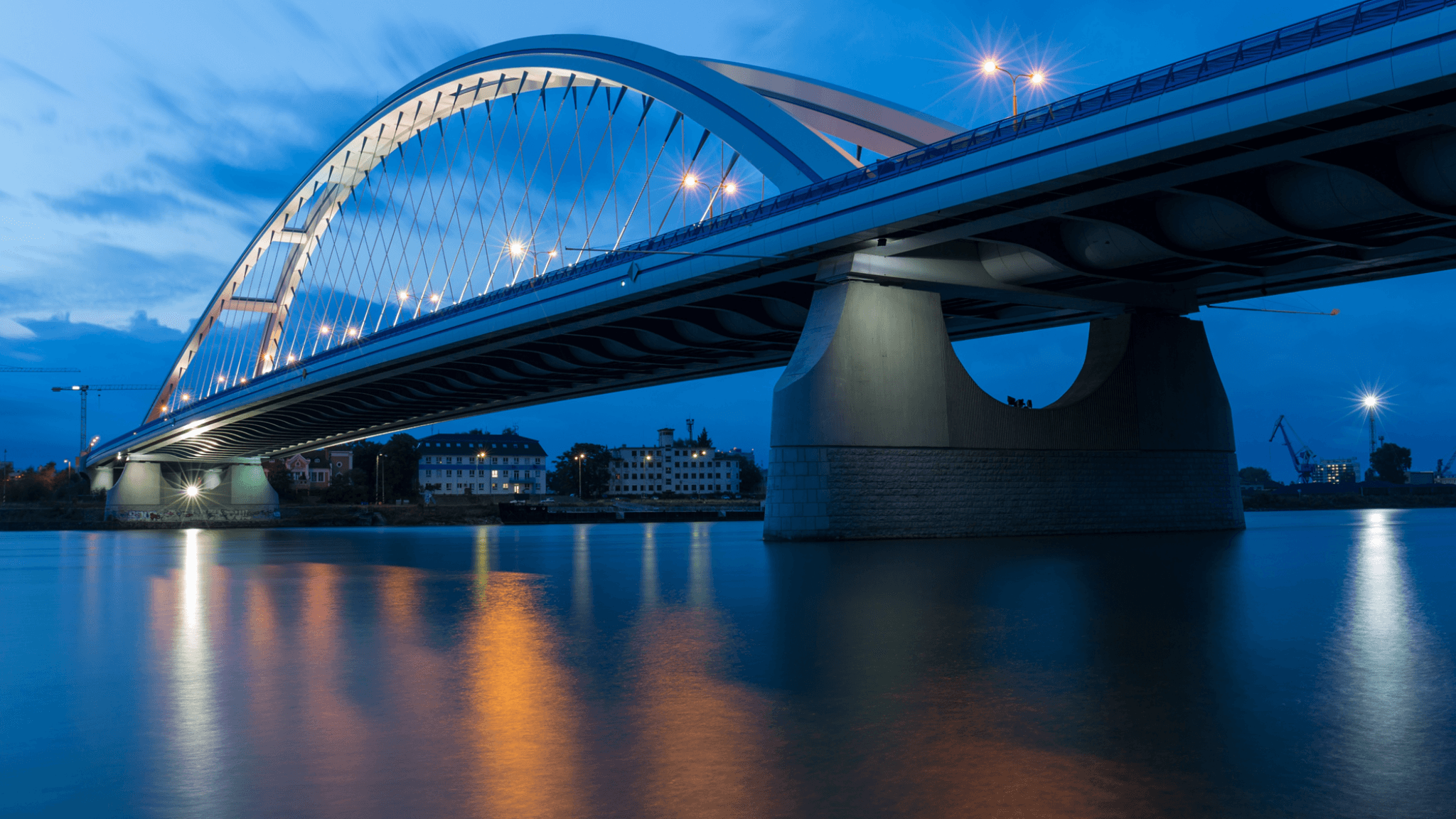 Bridge at dusk over calm water